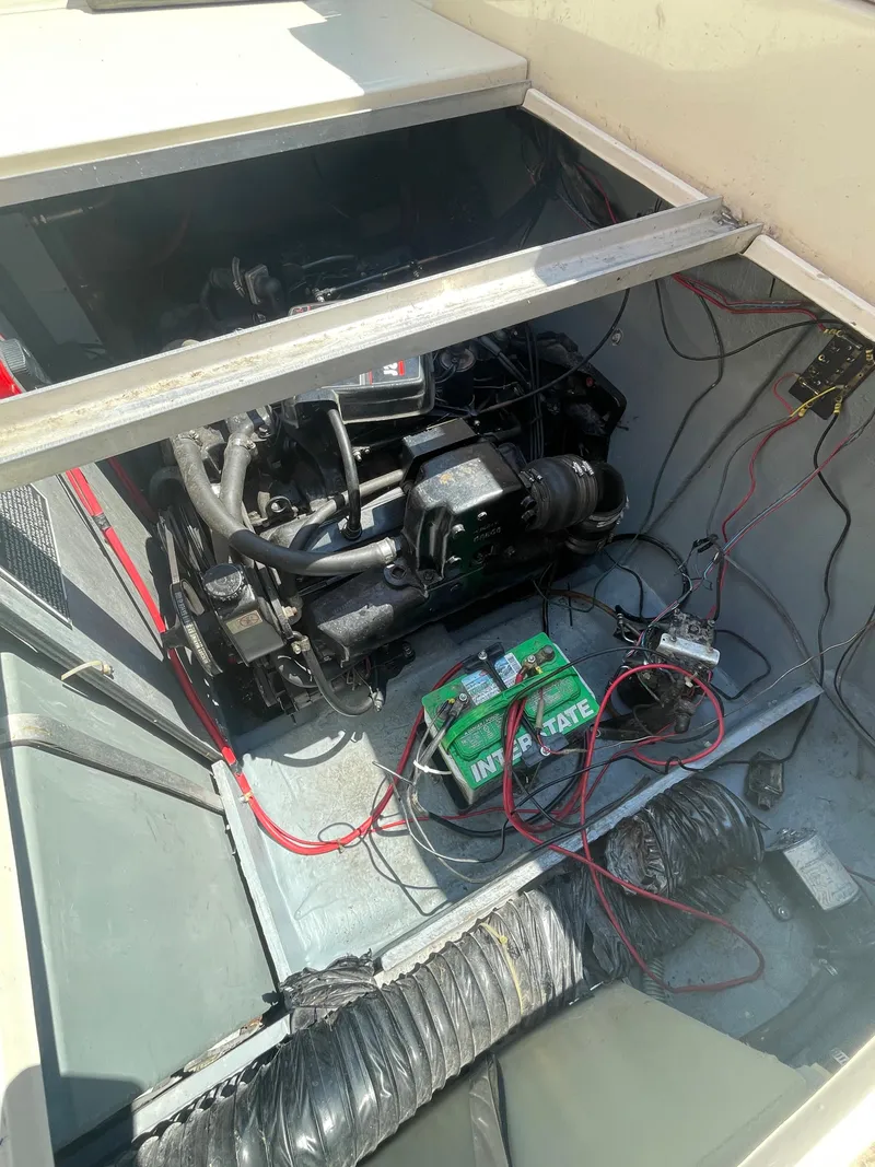 Slide: The Image of Engine compartment of a 1986 Sea Ray 268 Weekender boat, showing battery and wiring. - 29