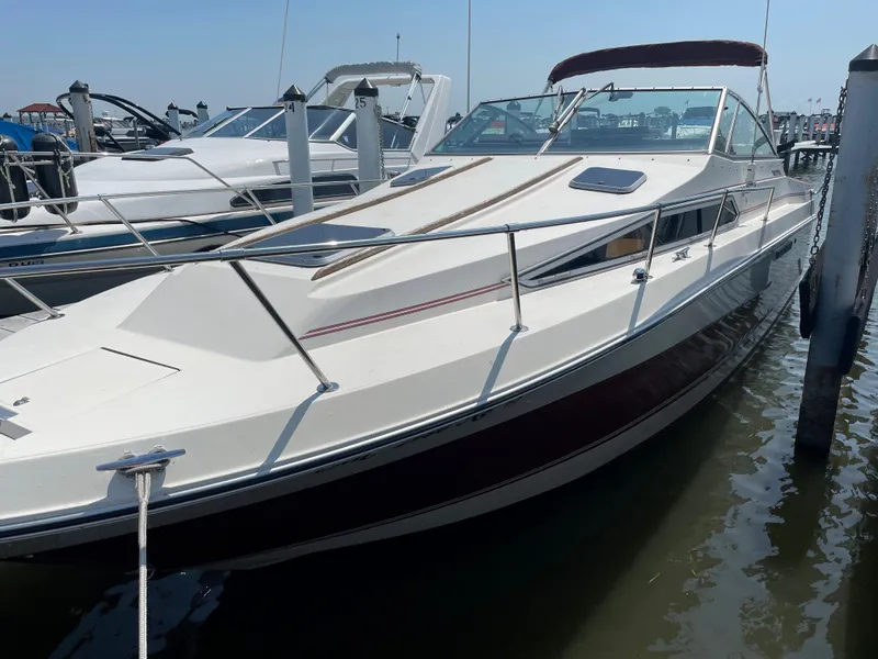 Slide: The Image of 1986 Sea Ray 268 Weekender boat docked in marina, side view. - 5