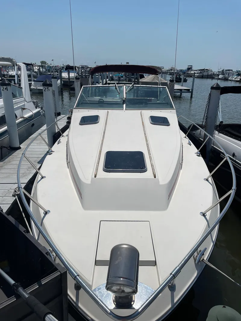 Slide: The Image of 1986 Sea Ray 268 Weekender docked at marina, showcasing sleek design and spacious deck. - 6