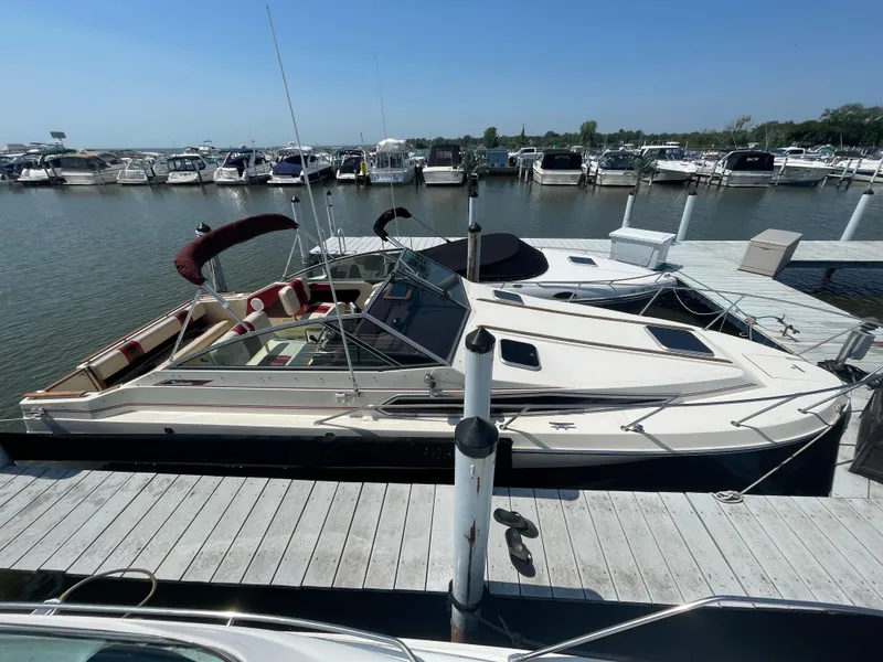 Slide: The Image of 1986 Sea Ray 268 Weekender docked at marina, sunny day, calm waters. - 8