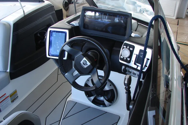 Slide: The Image of 2021 Malibu Wakesetter 22 LSV dashboard with modern controls and touchscreen displays. - 24