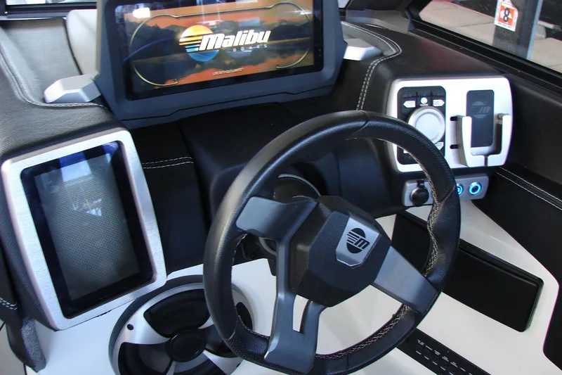 Slide: The Image of 2021 Malibu Wakesetter 22 LSV dashboard with steering wheel and control panel. - 31