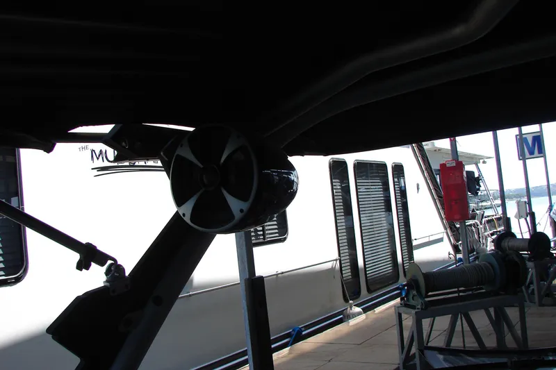 Slide: The Image of 2021 Malibu Wakesetter 22 LSV boat with visible speaker and docked houseboat. - 42