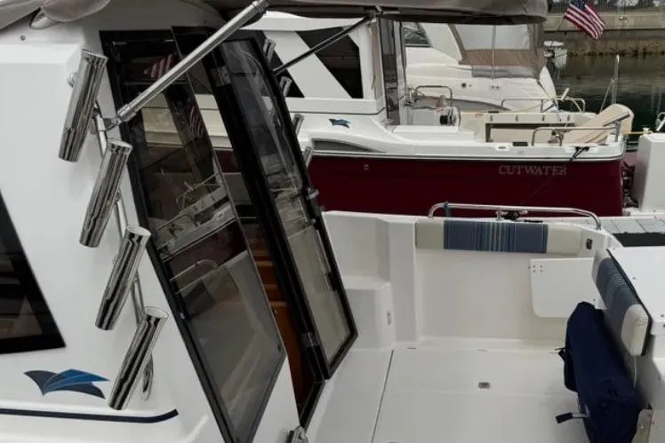Slide: The Image of 2019 Cutwater C-24 Coupe boat docked, featuring sleek design and spacious deck area. - 12