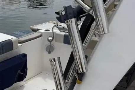 Slide: The Image of 2019 Cutwater C-24 Coupe boat with stainless steel rod holders and seating area. - 16