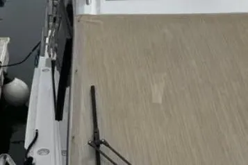 Slide: The Image of 2019 Cutwater C-24 Coupe boat deck with wood finish, docked at marina. - 17