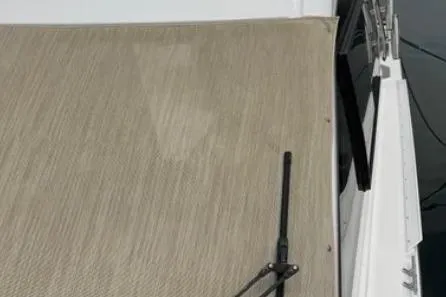 Slide: The Image of 2019 Cutwater C-24 Coupe boat deck with beige flooring and railing. - 18