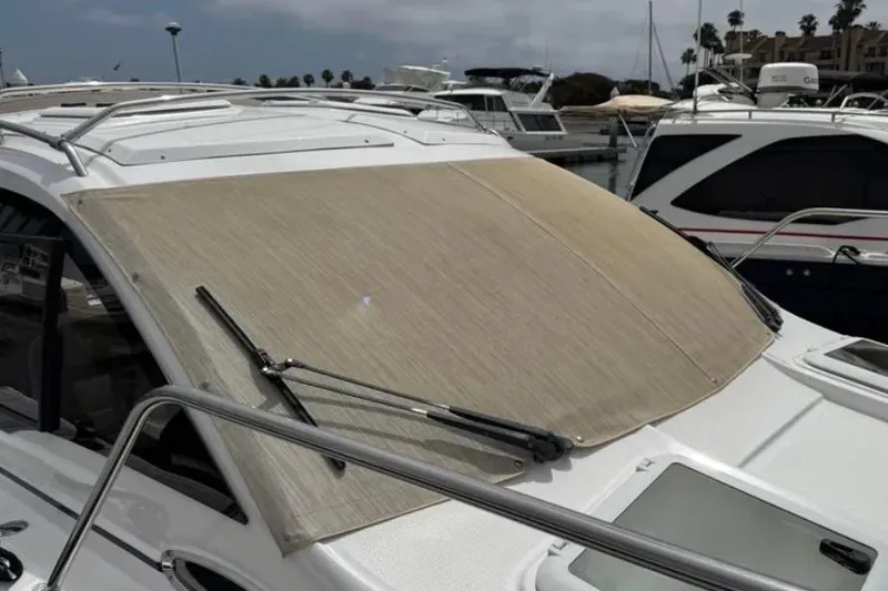 Slide: The Image of 2019 Cutwater C-24 Coupe with windshield cover at marina. - 19
