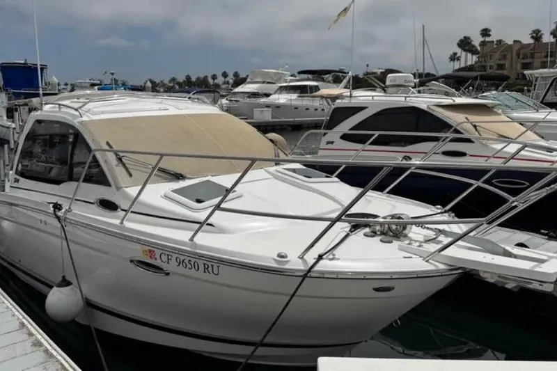 Slide: The Image of 2019 Cutwater C-24 Coupe docked at a marina with other boats. - 2