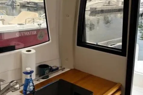 Slide: The Image of Interior view of a 2019 Cutwater C-24 Coupe boat with a sink and window. - 31