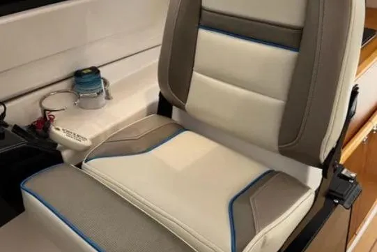 Slide: The Image of 2019 Cutwater C-24 Coupe interior seat with beige and brown upholstery, blue accents. - 32