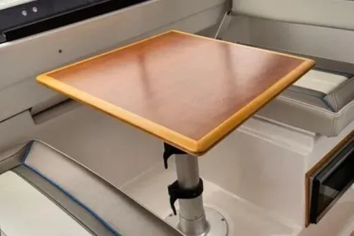 Slide: The Image of Interior of 2019 Cutwater C-24 Coupe featuring a wooden table and cushioned seating. - 35