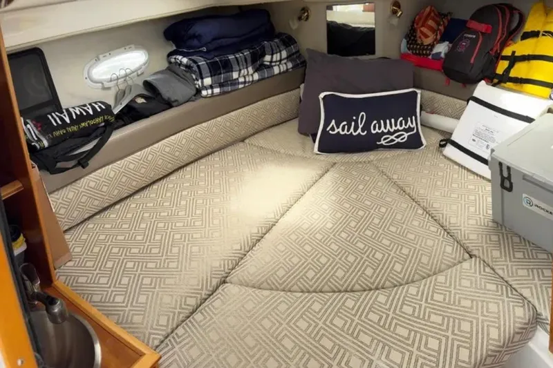 Slide: The Image of 2019 Cutwater C-24 Coupe cabin interior with cozy bedding and nautical decor. - 37