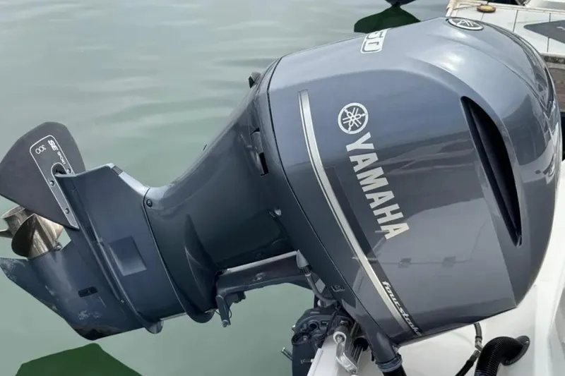 Slide: The Image of Yamaha outboard motor on 2019 Cutwater C-24 Coupe boat, docked on calm water. - 39