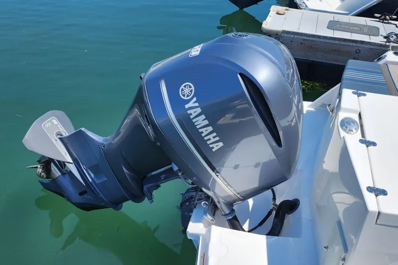 Slide: The Image of Yamaha outboard motor on 2019 Cutwater C-24 Coupe boat, docked in clear water. - 40