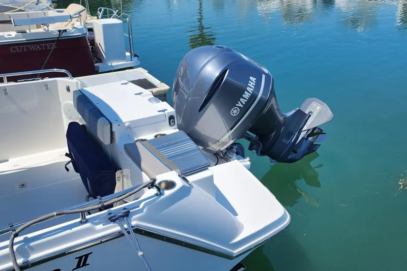 Slide: The Image of 2019 Cutwater C-24 Coupe with Yamaha outboard motor docked on calm water. - 41