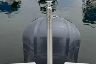 Slide: The Image of 2019 Cutwater C-24 Coupe boat bow in marina, reflecting on calm water. - 43