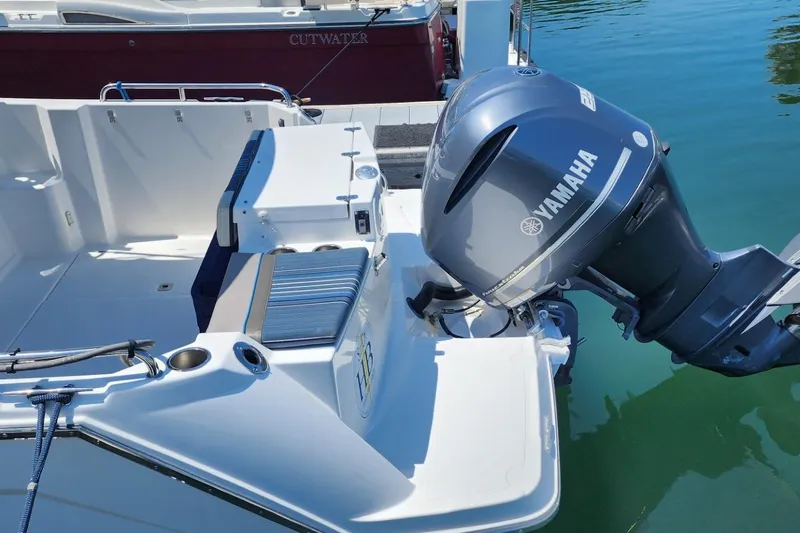 Slide: The Image of 2019 Cutwater C-24 Coupe with Yamaha outboard motor, docked on calm water. - 44