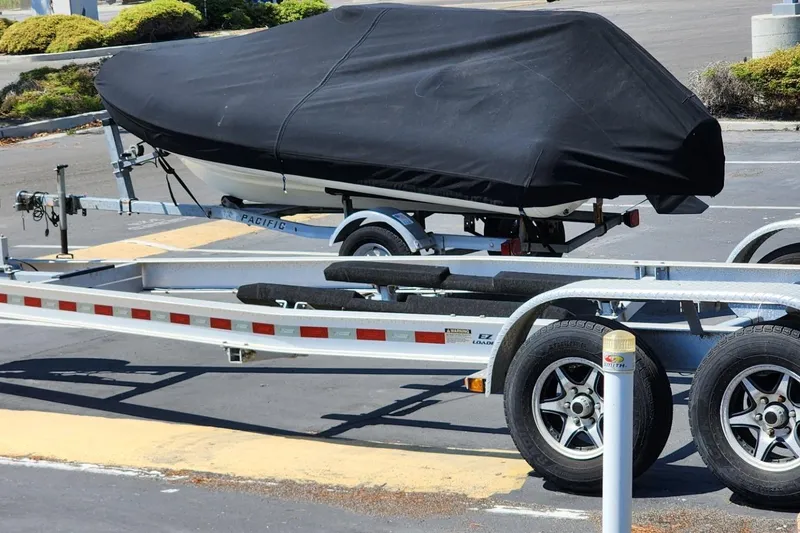 Slide: The Image of 2019 Cutwater C-24 Coupe covered on trailer in parking lot. - 47