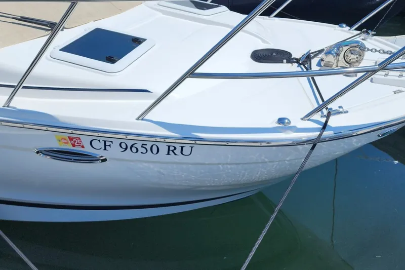 Slide: The Image of 2019 Cutwater C-24 Coupe boat docked, displaying registration number CF 9650 RU. - 5