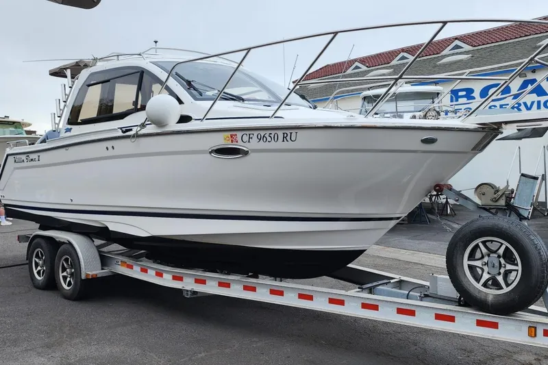 Slide: The Image of 2019 Cutwater C-24 Coupe boat on trailer at marina, side view. - 50