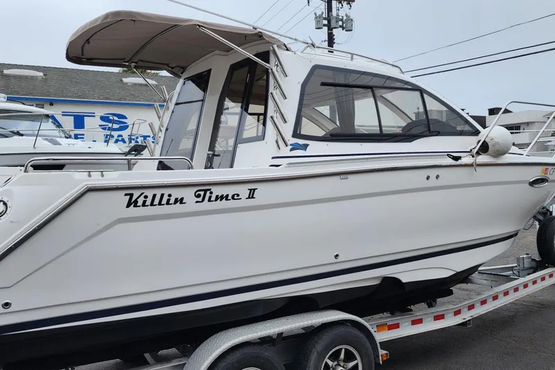 Slide: The Image of 2019 Cutwater C-24 Coupe boat named "Killin Time II" on a trailer. - 53