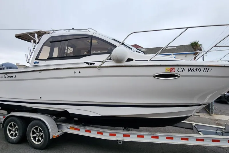 Slide: The Image of 2019 Cutwater C-24 Coupe boat on trailer, side view, white exterior. - 54