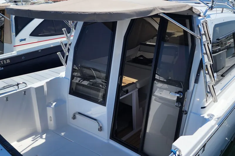 Slide: The Image of 2019 Cutwater C-24 Coupe boat with covered cockpit and sleek design. - 7