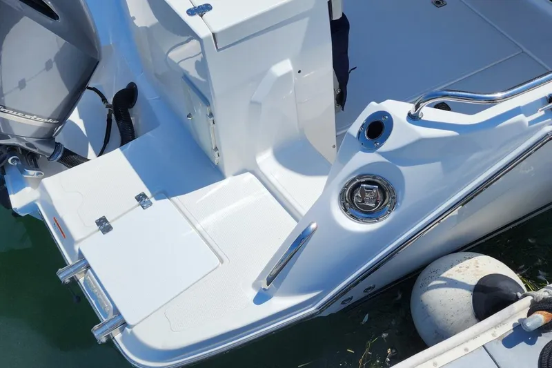 Slide: The Image of 2019 Cutwater C-24 Coupe boat stern with swim platform and outboard motor. - 8