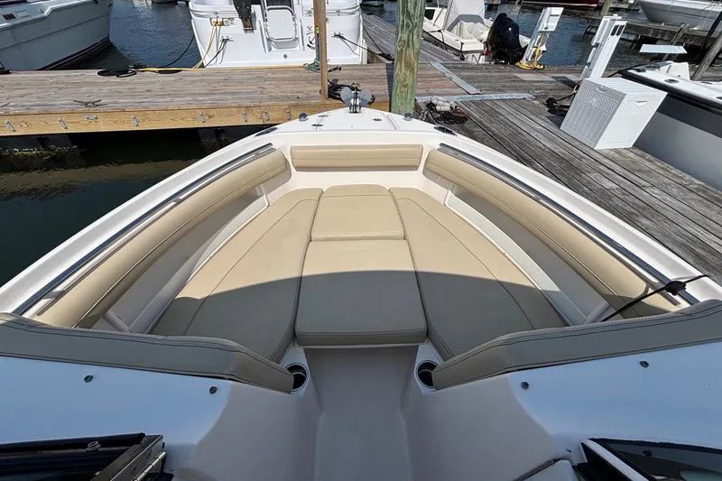 Slide: The Image of 2017 Pursuit DC 235 Dual Console boat with spacious seating at dock. - 10