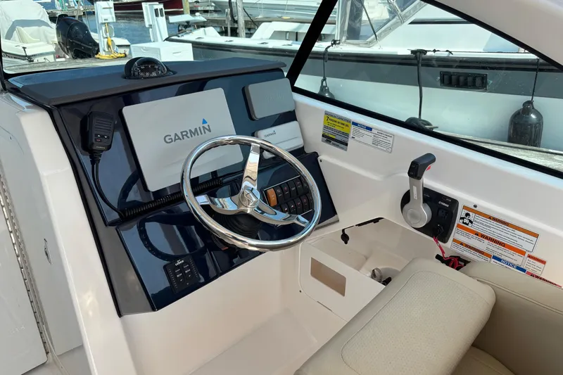 Slide: The Image of 2017 Pursuit DC 235 Dual Console boat dashboard with Garmin navigation system. - 14