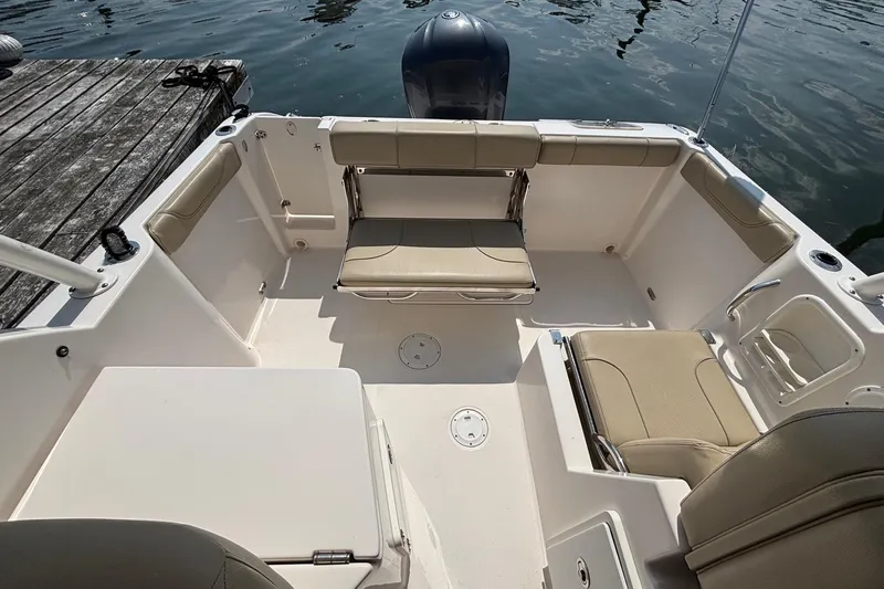 Slide: The Image of 2017 Pursuit DC 235 Dual Console boat interior with seating and water view. - 19