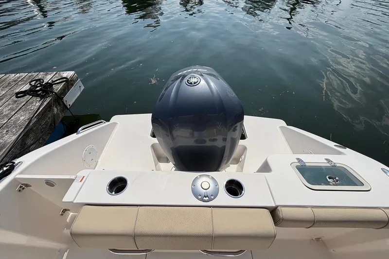 Slide: The Image of 2017 Pursuit DC 235 Dual Console boat with outboard motor at dock. - 20