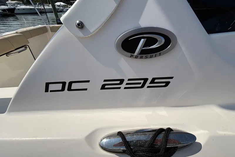 Slide: The Image of 2017 Pursuit DC 235 Dual Console boat with logo and model name visible. - 25