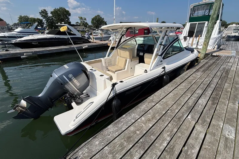 Slide: The Image of 2017 Pursuit DC 235 Dual Console boat docked with Yamaha outboard motor. - 6