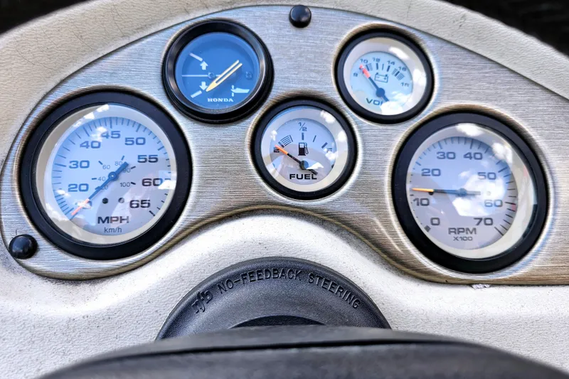 Slide: The Image of Dashboard of a 2000 Alumacraft Navigator 165 CS boat with speedometer and fuel gauges. - 14