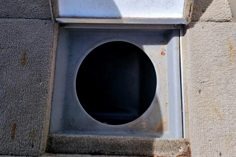 Slide: The Image of Alumacraft Navigator 165 CS 2000 boat compartment with circular opening and carpeted surface. - 20