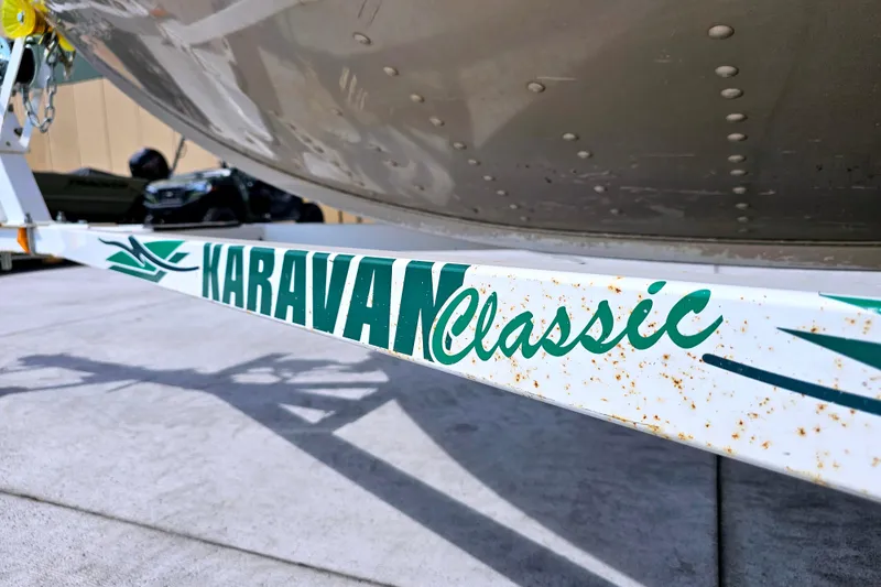 Slide: The Image of Karavan Classic trailer with Alumacraft Navigator 165 CS boat, 2000 model, parked outdoors. - 26