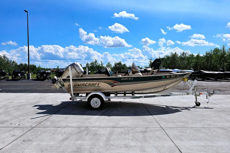 Slide: The Image of 2000 Alumacraft Navigator 165 CS boat on trailer under blue sky. - 3