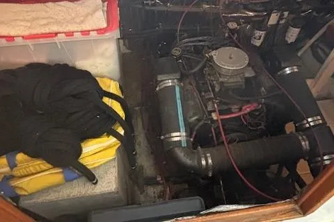 Slide: The Image of Engine compartment of a 1990 Bayliner 3888 with visible storage items. - 18