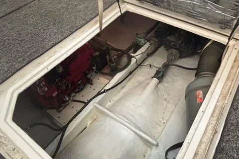 Slide: The Image of Engine compartment of a 1990 Bayliner 3888 boat, showcasing mechanical components. - 19