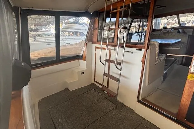Slide: The Image of Interior of a 1990 Bayliner 3888 yacht with ladder and seating area. - 21