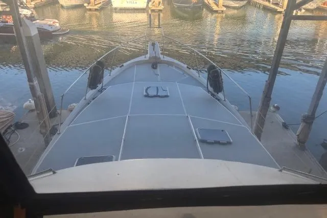 Slide: The Image of 1990 Bayliner 3888 yacht docked at marina, viewed from the deck. - 25