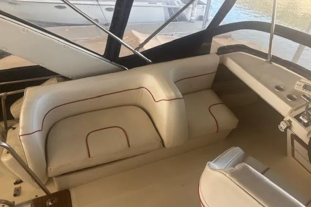 Slide: The Image of 1990 Bayliner 3888 interior with white seating and control panel. - 29
