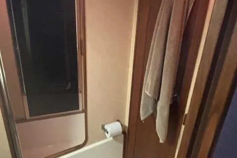 Slide: The Image of Bathroom interior of a 1990 Bayliner 3888 yacht with towel and mirror. - 8