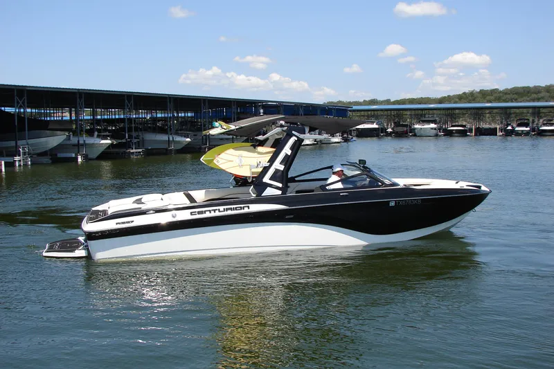 Slide: The Image of 2019 Centurion Ri257 boat on water near marina, clear sky background. - 10