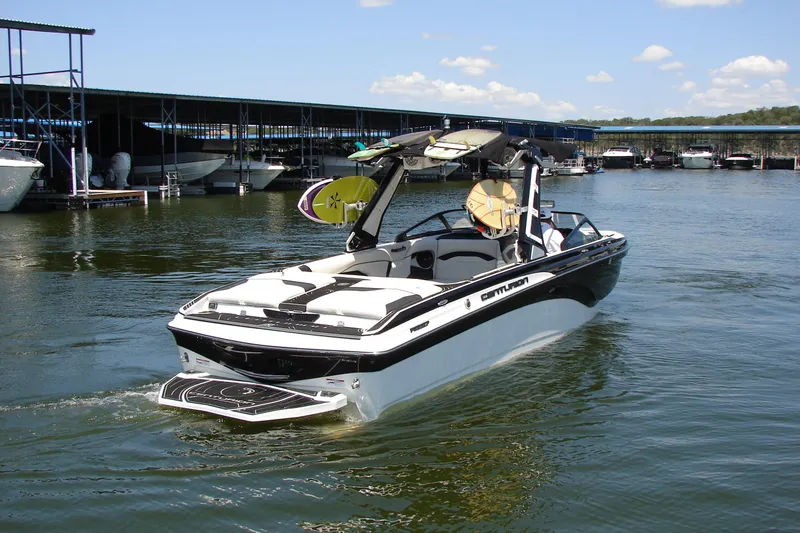 Slide: The Image of 2019 Centurion Ri257 boat docked on calm water, featuring sleek design and wakeboard equipment. - 12