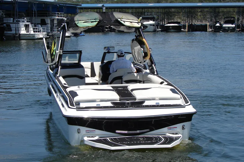 Slide: The Image of 2019 Centurion Ri257 boat on water, rear view with wakeboard tower. - 13