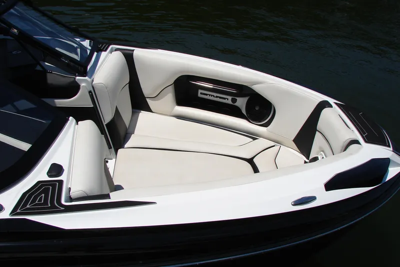 Slide: The Image of 2019 Centurion Ri257 boat interior with white and black seating, on calm water. - 17