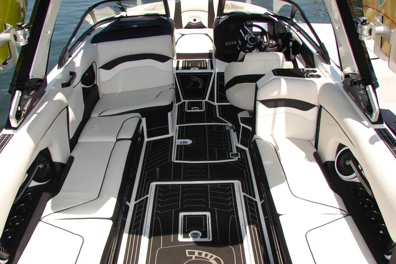 Slide: The Image of 2019 Centurion Ri257 boat interior with sleek white seating and modern dashboard design. - 25